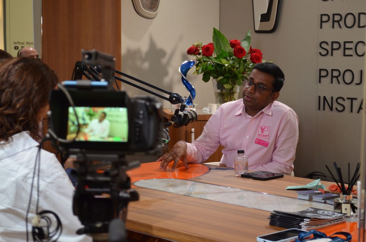 Sanjeev Gabriel being interviewed on camera at a yachting event