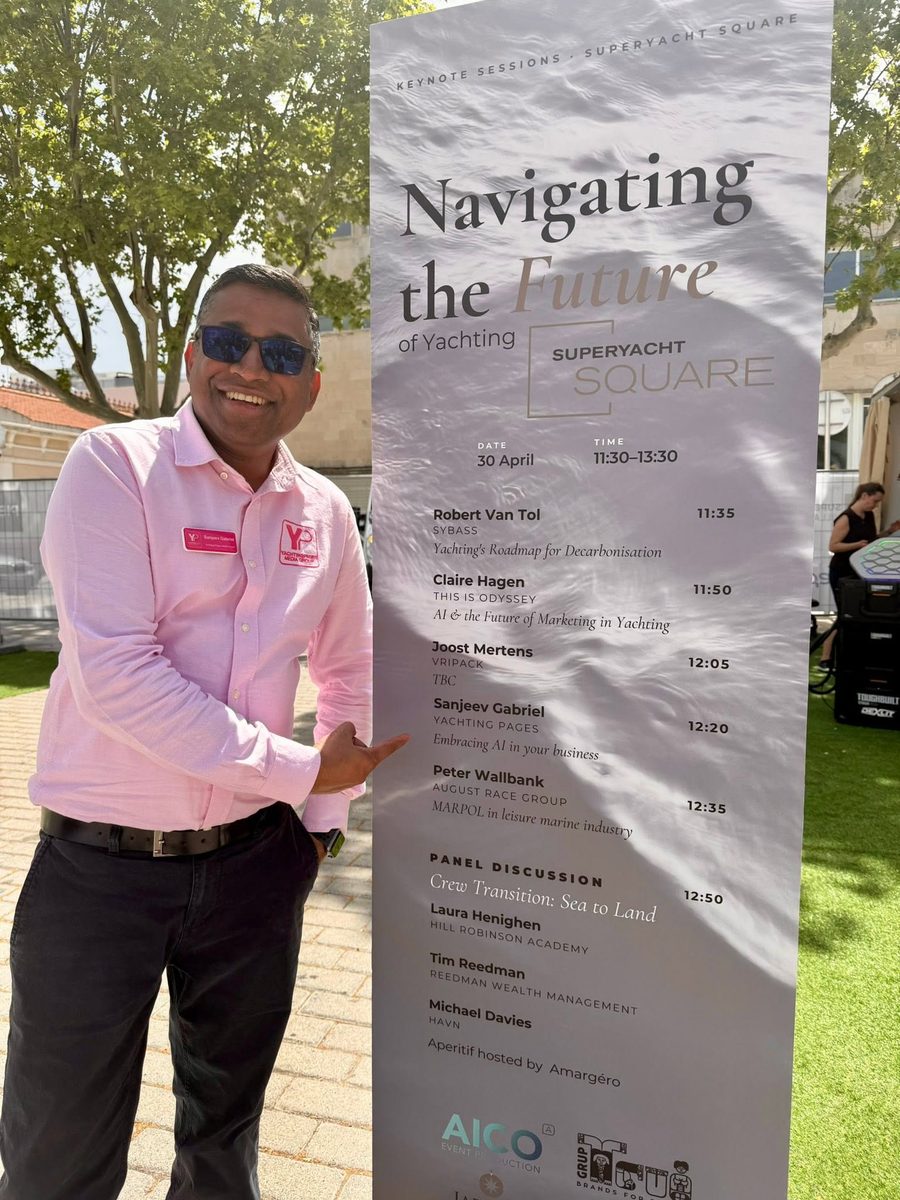 Sanjeev Gabriel pointing to the Superyacht Square keynote programme listing his talk 'Embracing AI in your business'